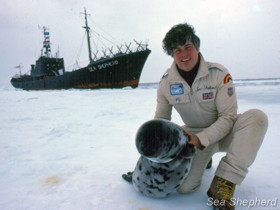 Captain Watson takes a moment to post with a seal