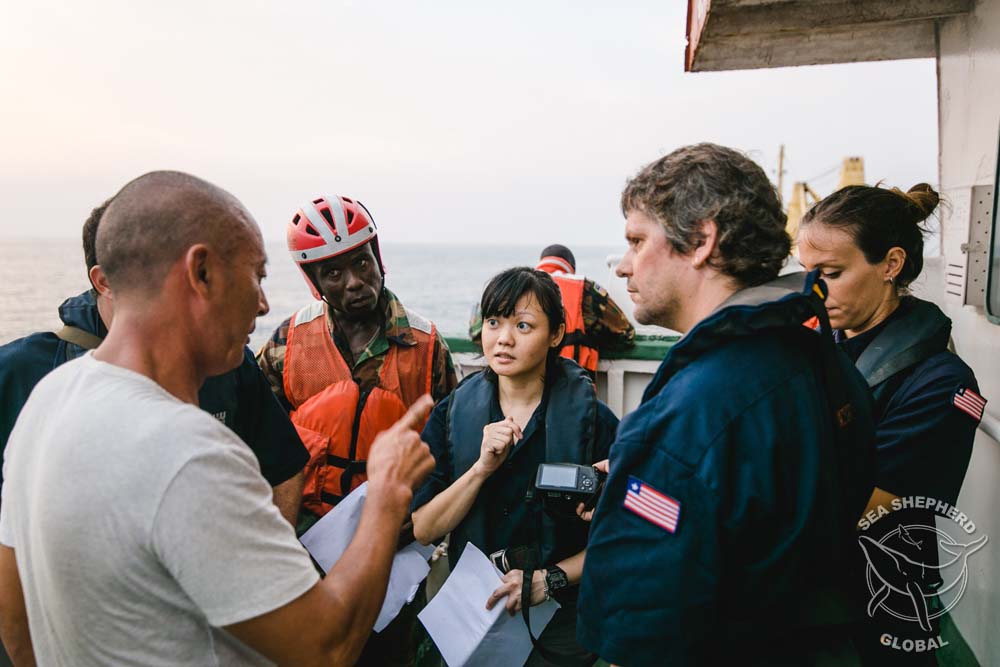 Sea Shepherd's IUU Task Force team and Liberian Coast Guard question the reefer crew. Photo: Michael Rauch/Sea Shepherd Global.