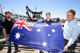 Mayor Brad Pettitt, Captain Locky MacLean and Jeff Hansen proudly display the Australian flag