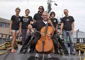 Cellist Michael Goldschlager with crew members of the Bob Barker in Hobart. Photo: Carolina A. Castro