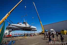 The Brigitte Bardot is hoisted by cranes from its repair site to the water. Photo: Simon Ager