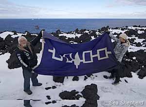 Captain Paul Watson and crewmember Shannon Mann raise the Five Nations Iroquois Confederacy flag on Scott Island in the Southern Ocean  -  photo: Billy Danger/Sea Shepherd 