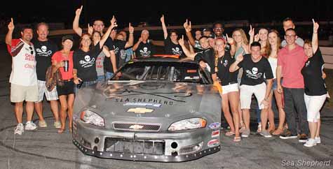 Racecar Driver Zack Jarrell, pit crew, supporters and Sea Shepherd Onshore Crewmembers at the FASCAR Pro Late Models 100 race at Florida's New Smyrna Speedway